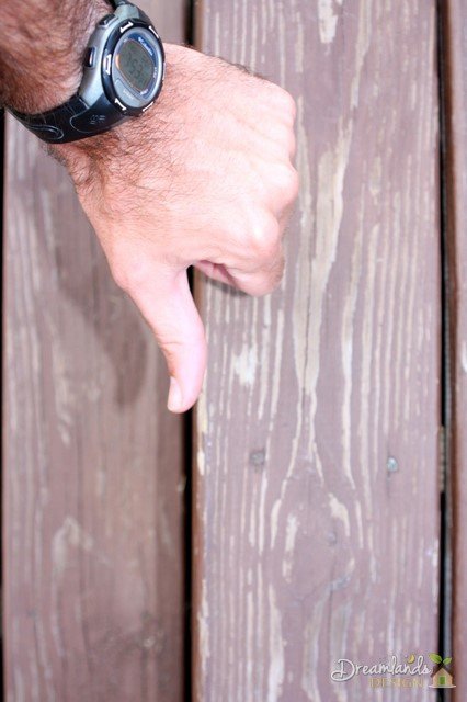 A close up shows that there is a significant amount of stain that has flaked off after only a year A close up shows that there is a significant amount of stain that has flaked off after only a year