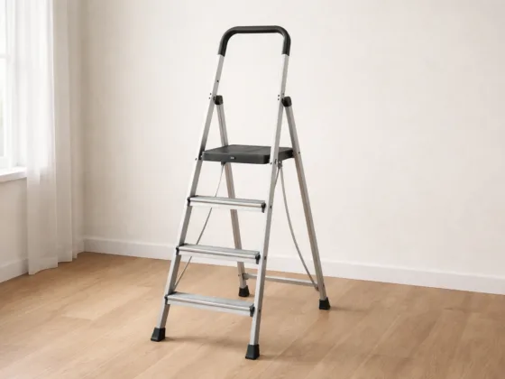 Platform step ladder with wide standing surface and handrail positioned securely on a flat indoor floor