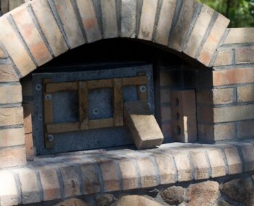 featured image - How to Use an Outdoor Brick Oven to Bake Pizza