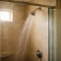 Shower water flow in a bathroom affected by hard water