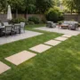 Backyard prepared for a gathering with defined lawn walkways and patio seating