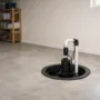 Installed sump pump system in residential basement concrete floor basin