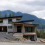 Partially built home on a sloped lot in Squamish surrounded by forest and mountains