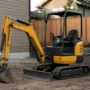 mini excavator in residential backyard construction site idle