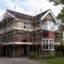 Residential scaffolding installed around a two-story home during exterior renovation work