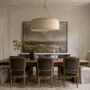 Dining room updated with wall molding, artwork, layered lighting, and neutral furnishings without structural remodeling
