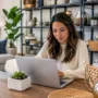 Woman comparing home décor products on an online marketplace before buying furniture and decorative accessories.