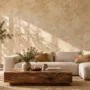 A modern living room featuring a warm beige limewash textured wall paired with a natural linen sofa and walnut wood furniture