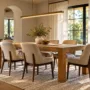 A beautifully styled timber dining table illuminated by a warm linear chandelier in an elegant dining room.